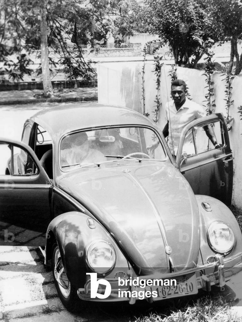 Brazilian soccer Edson Arantes do Nascimento aka pele and his car (Volkswagen beetle) in Santos December 1964