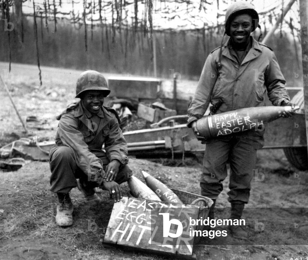 William E. Thomas and Pfc. Joseph Jackson prepare to roll 'eggs' on Adolf Hitler's lawn, Easter Morning, 1945 (b/w photo)