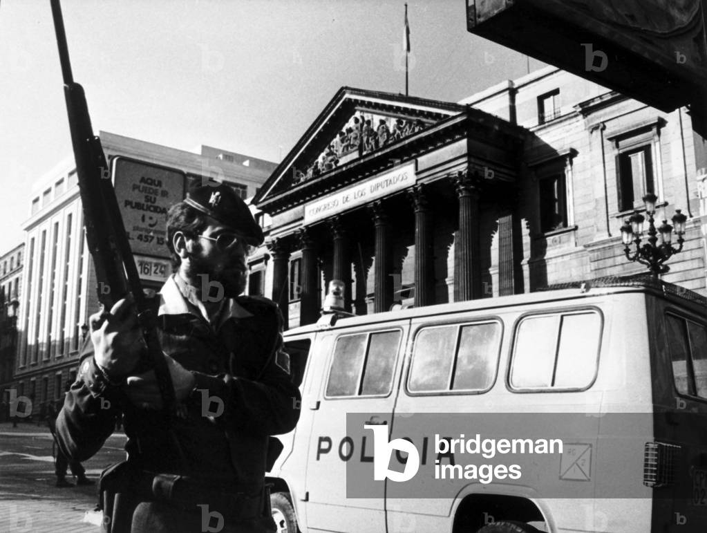 The Cortes facade with a police bus and a police officer in the foreground after the events of 23 February 1981 (the coup de force) in Madrid. Neg: B23947PL