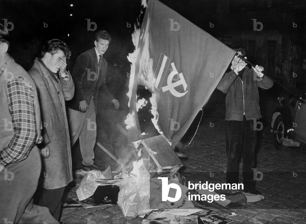 Demonstration against communism in Austria (Vienne). Here, a student throwing the communist flag on the bonfire, Vienne, 1956