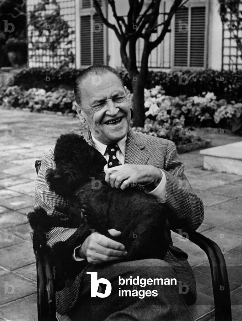 William Somerset Maugham (1874-1965) English writer, with his dog, February 1954