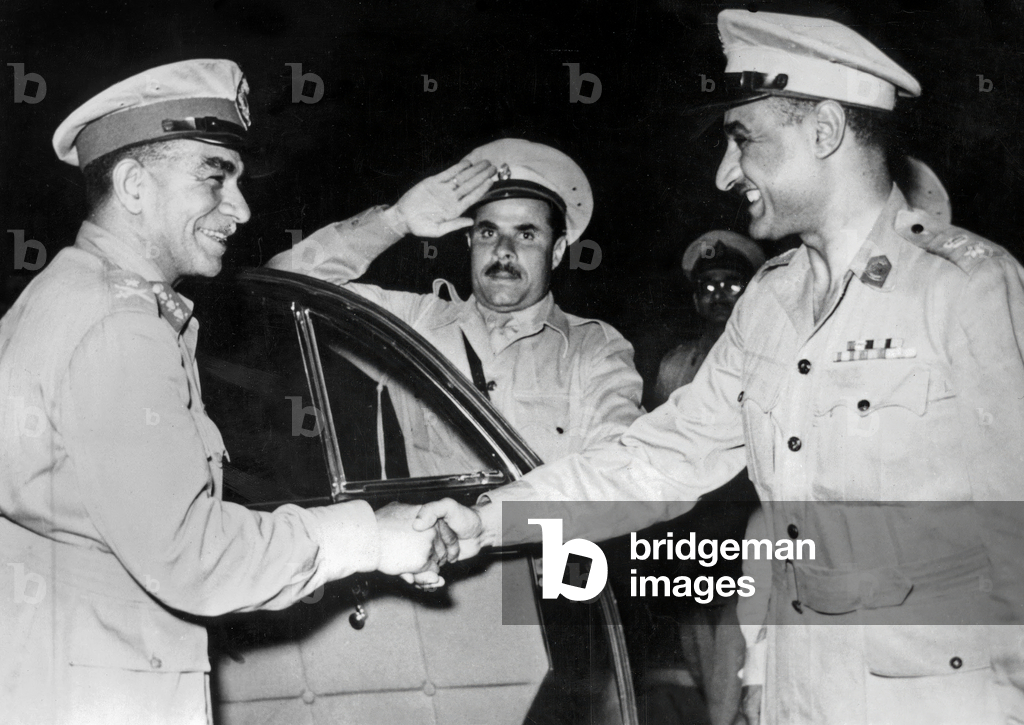 General Mohammed Nagib (l) shaking hands with Colonel Gamal Abdel Nasser at Cairo on June 18, 1953 at declaration of Republic of Egypt