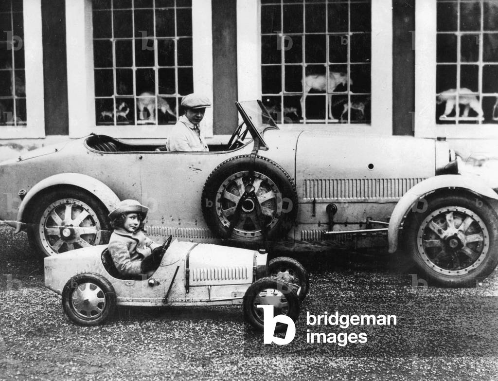 Jean Bugatti and Roland Bugatti in cars made by their father, c.1928 (b/w photo)