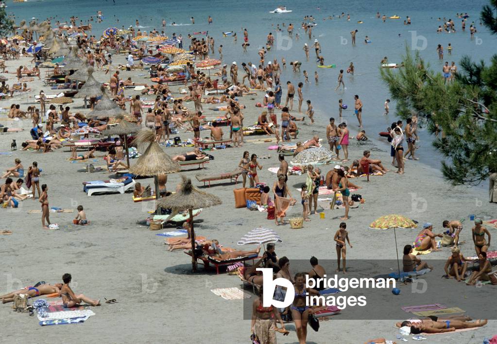 People at the beach of Palma Nova in Mallorca in Baleares (Spain) in July 1978