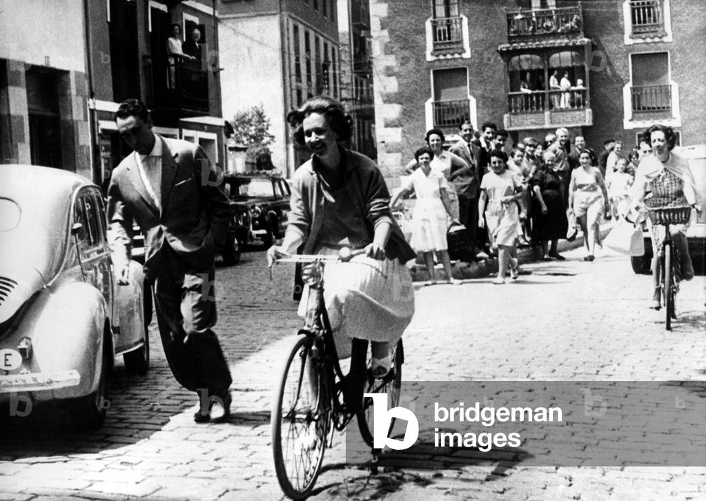 Queen of Belgians Fabiola cycling in streets of Zarautz during holidays in Spain, August 6, 1961