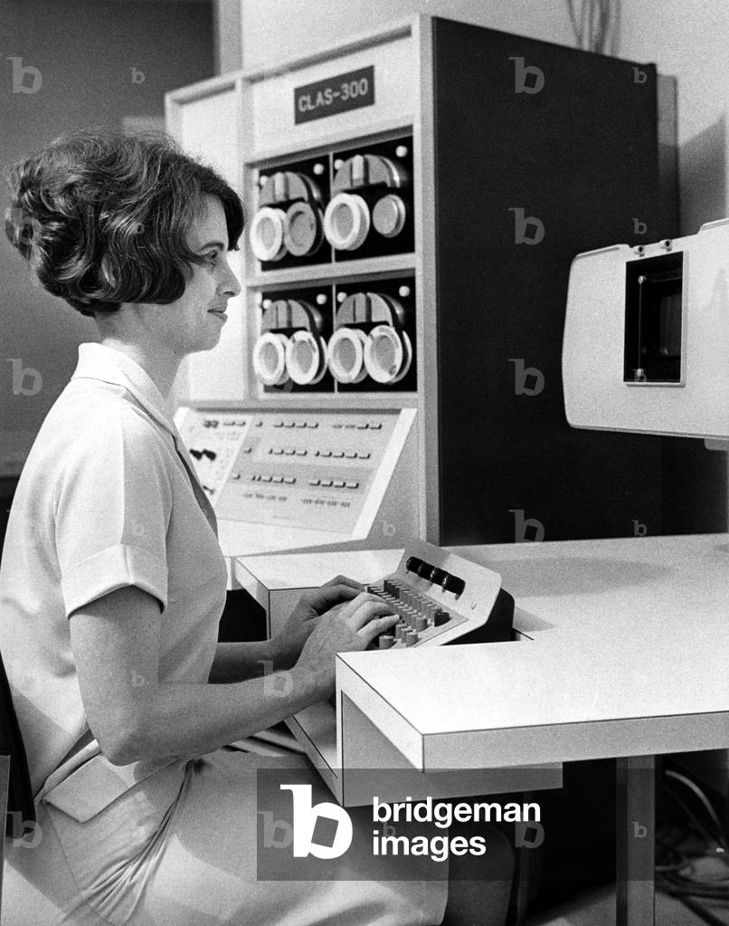 A secretary in the pathology dept. of St. Joseph's Hospital working on a computer. December 14, 1967