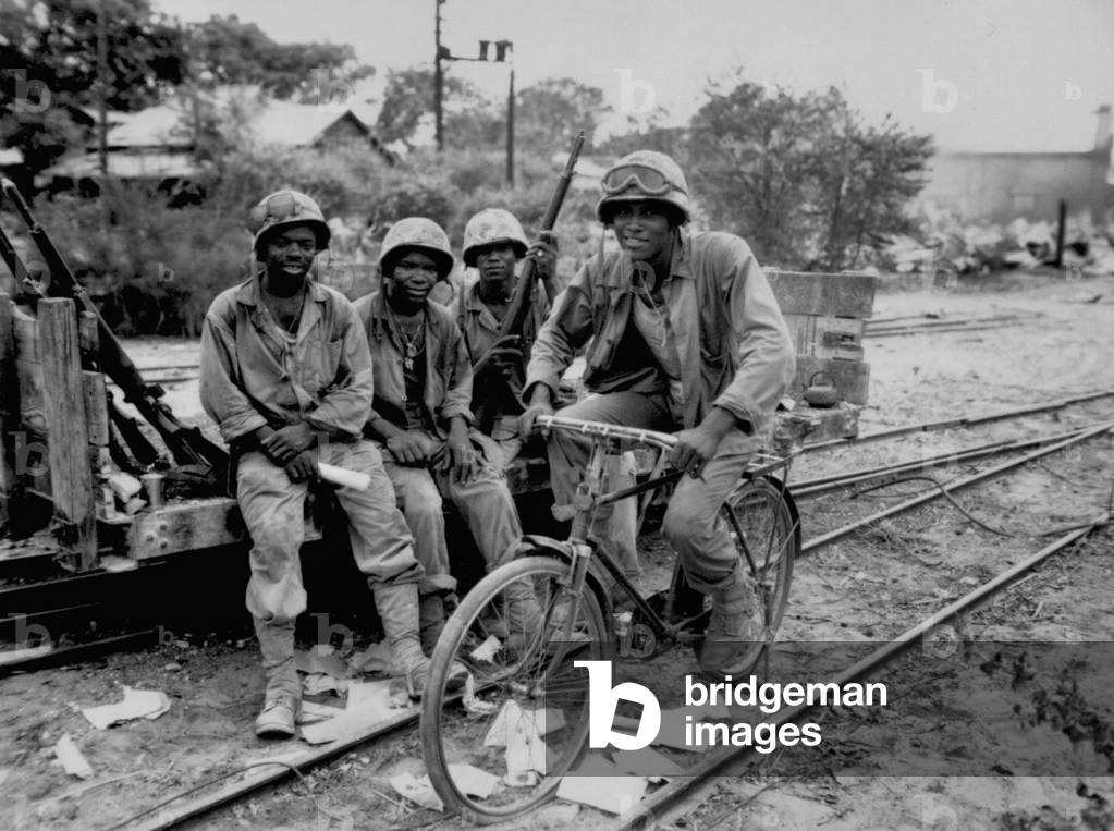 Horace Boykin (bike), right, Willis T. Anthony, Emmitt Shackelford and Eugene Purdy (Negro Marines, Third Ammunition Company) Saipan, June 1944