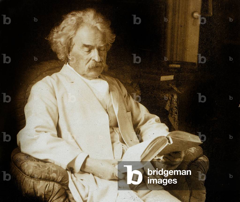 Mark Twain (Samuel Langhorne Clemens 1835-1910) American writer, here reading, c; 1910