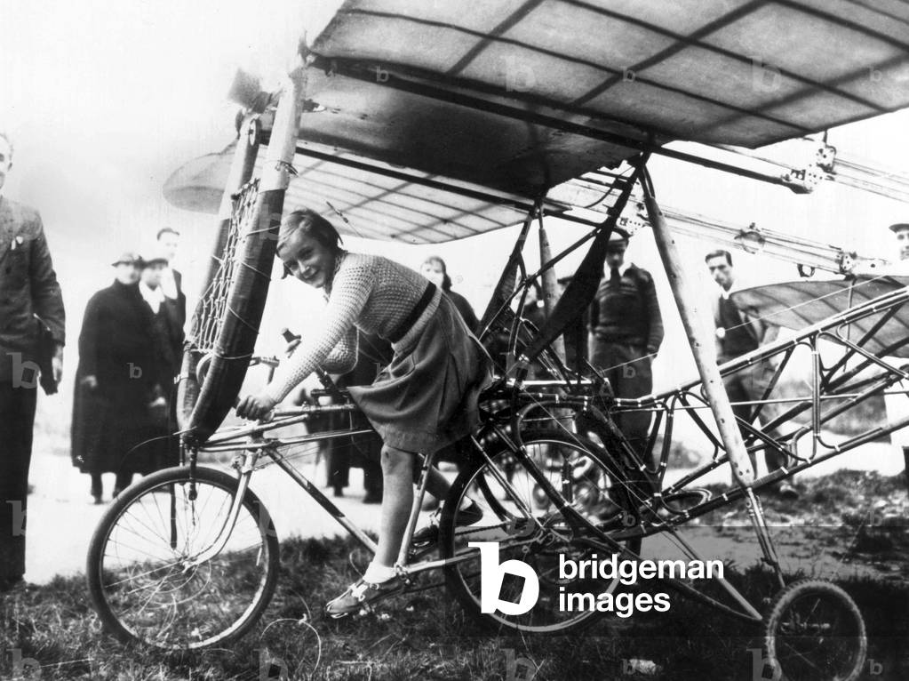 Beginning of the aviation : little girl on a flying bike, end of the 19th century