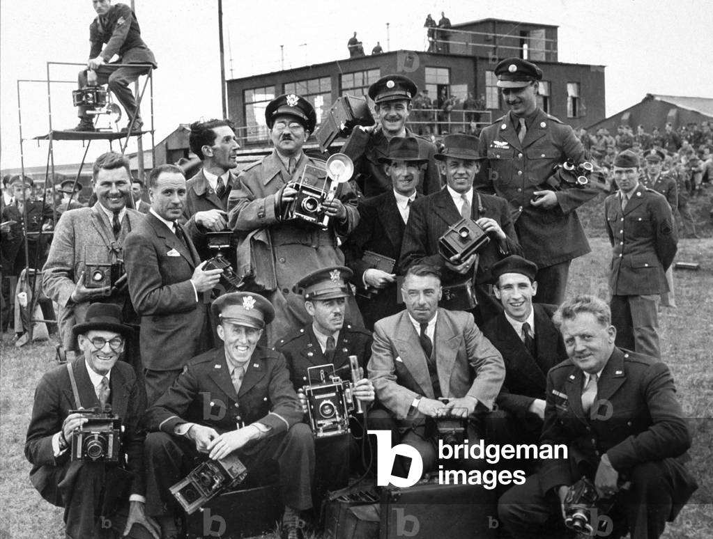 Civilian and military press corps posing together at arrival at airport, c. 1953