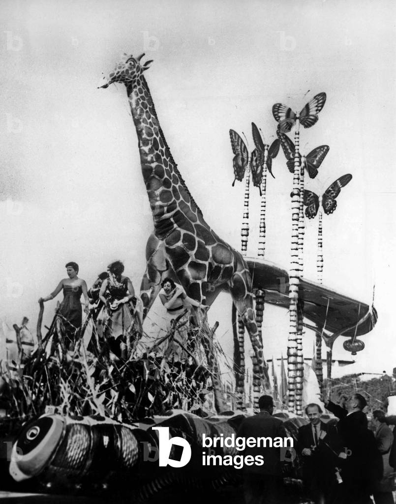 Theodore Dos Santos, rich portuguese industrialist 52 years old, organized Estoril carnival in Portugal. Here in the procession, we can see the giraffe made by Salvador Dali, February 10, 1959