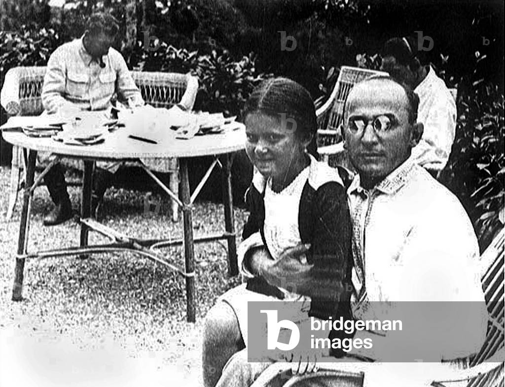 Joseph Staline (1879-1953) in the background with Lavrenti Beria and staline's daughter Sveltana and Jo with headphones behind, c. 1933