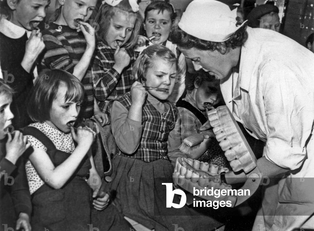 In a school in Austria, a nurse showing children how to brush their teeth, November 8, 1960