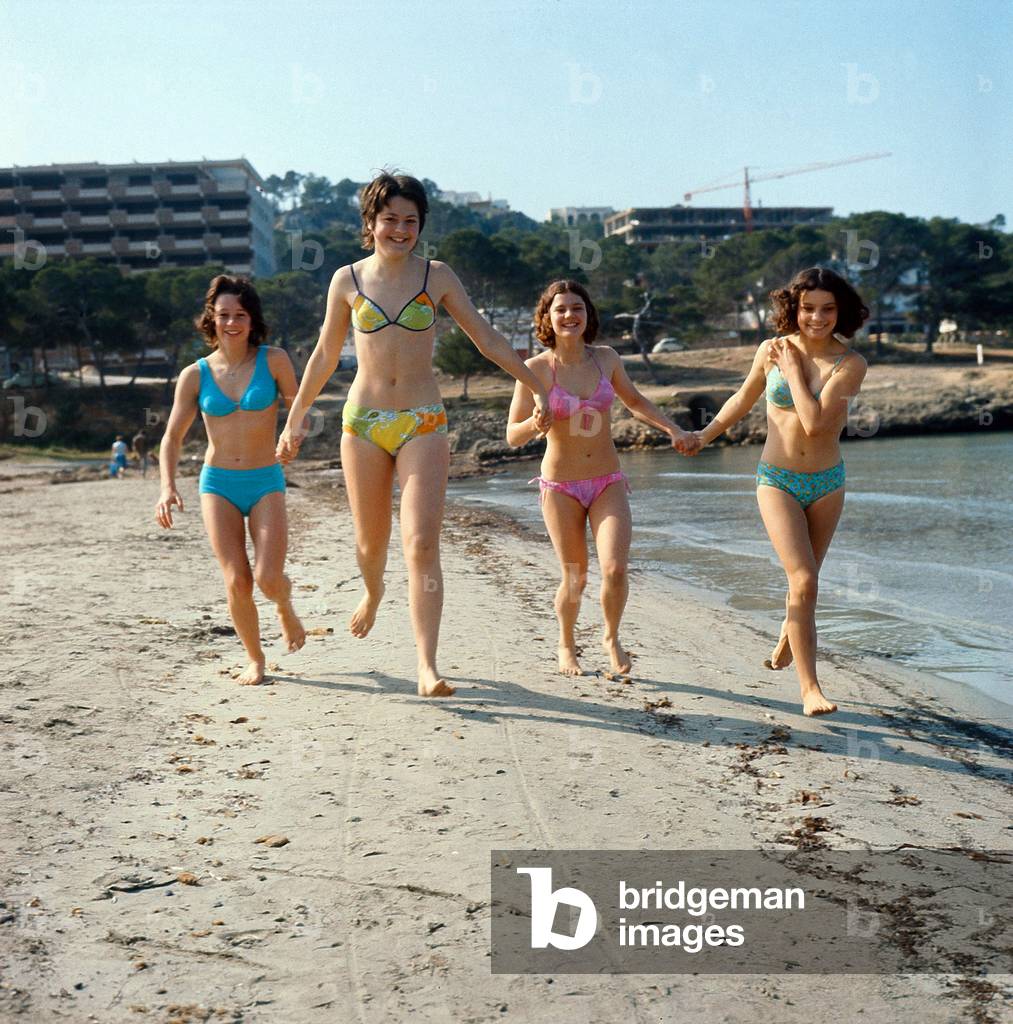 Girls running on the beach of Majorca in the Balearic Islands (Spain) in 1971