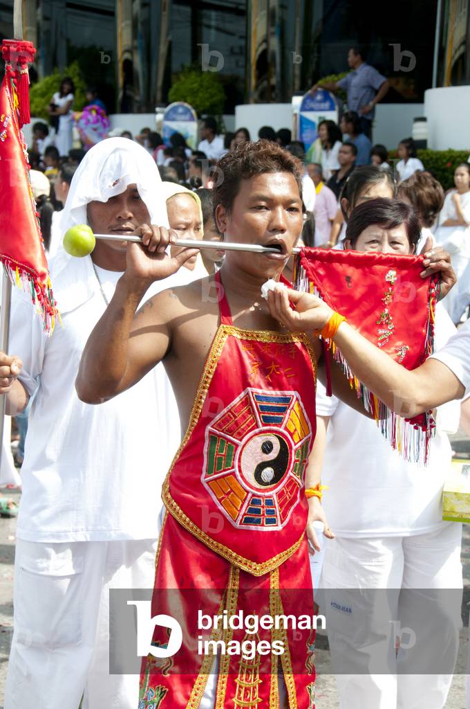 Thailand: An attendant wipes the mouth of a 'Ma Song' (entranced devotee), Phuket Vegetarian Festival