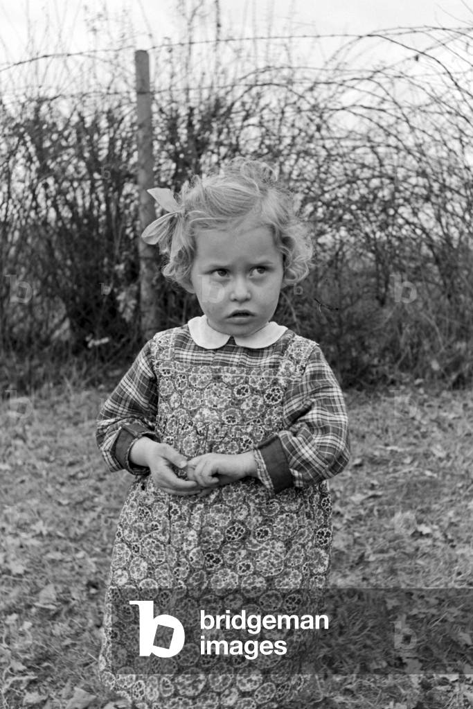 Image of Photography depicting One of Knipser's quadruplet girls playing at the garden, b/w