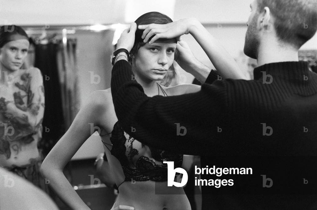 Bild von Fotografie "Designassistenten perfektionieren das Outfit eines Models für die kommende Armani-Modensc