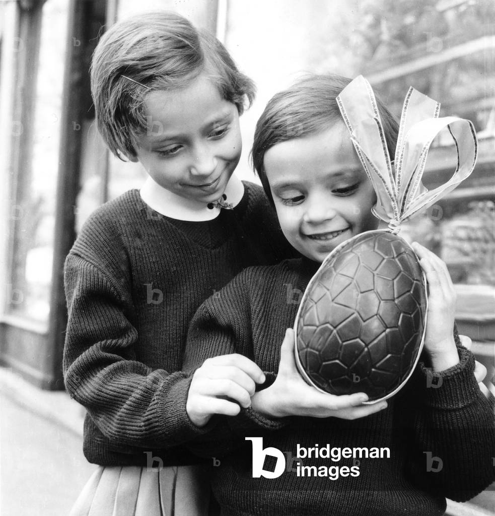 Image of Photography depicting Children with Delicacy Chocolate Eggs For Easter March 26 1945, b/w