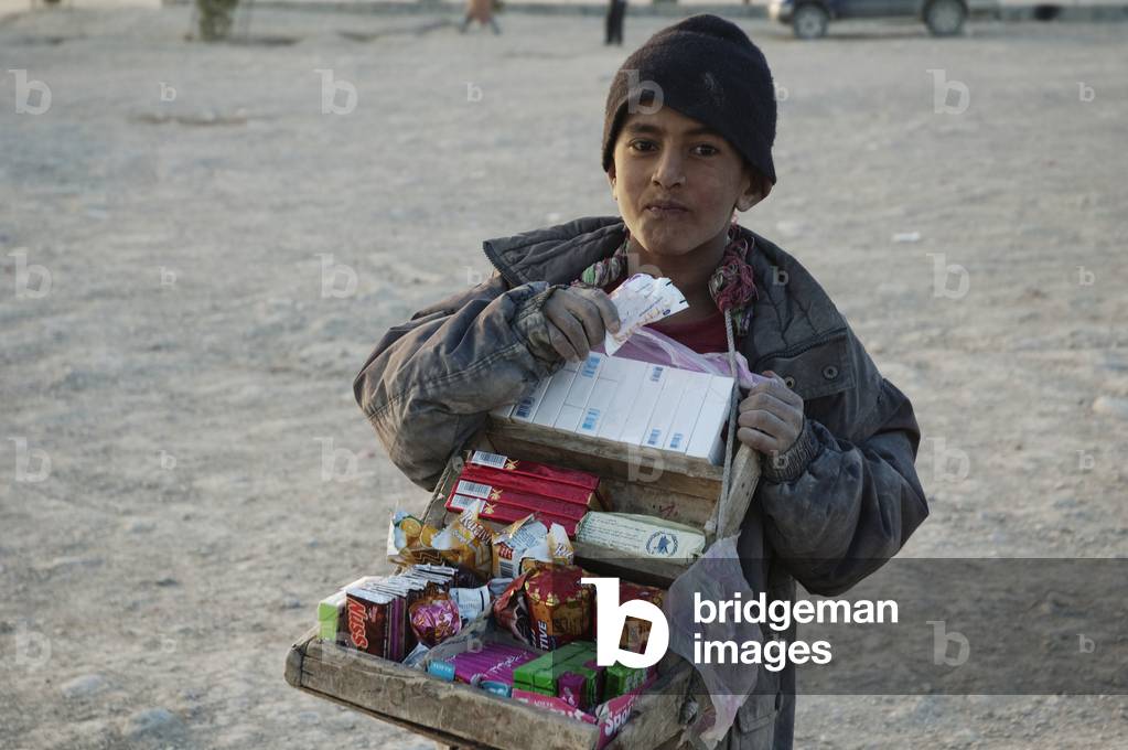 afghanistan cigarettes Image of Afghan Boy Selling Cigarettes and Candy on the Tapa Maranjan