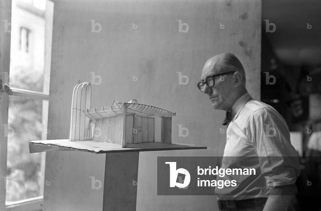 Le Corbusier looking at a scale model of Ronchamp Chapel, rue de Sevres, Paris, c.1957 (b/w photo)