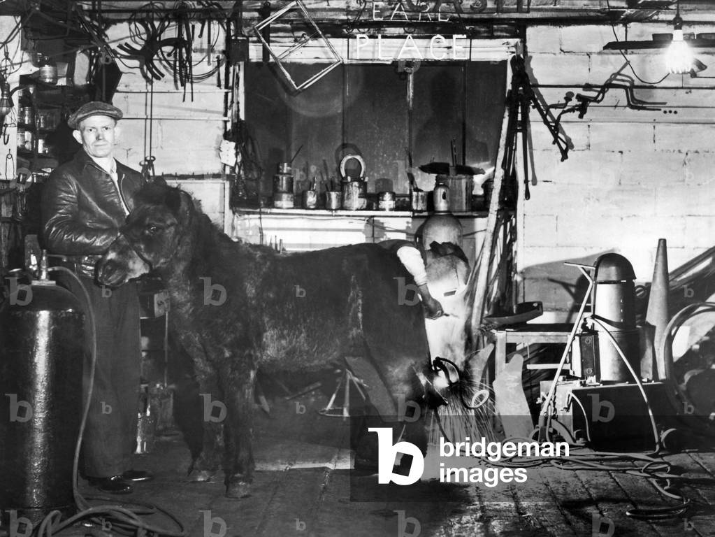 Image of Photography depicting Arcwelding Horseshoes 1945, b/w