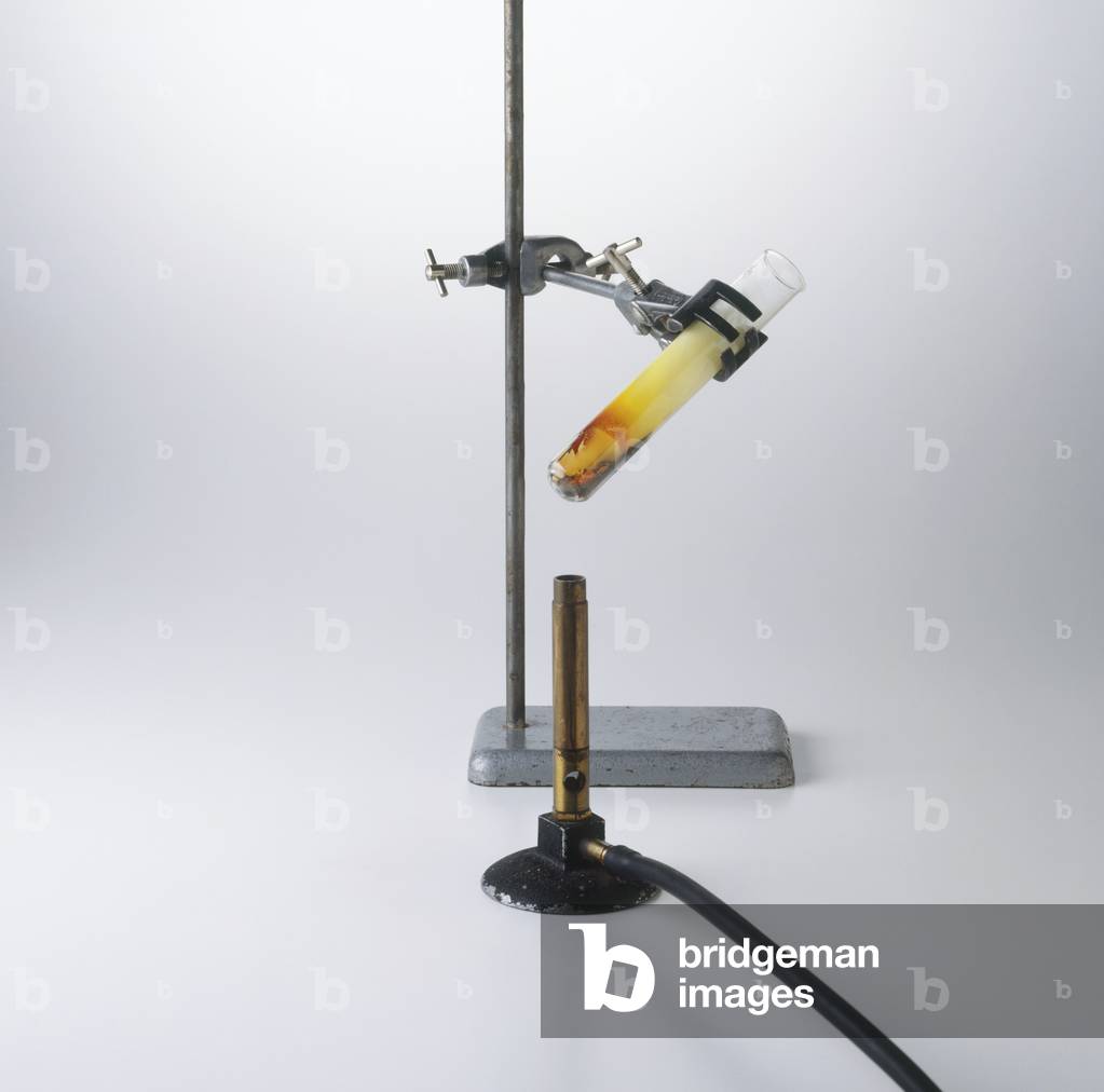 Image of Test tube of sulphur and iron mix held in tongs