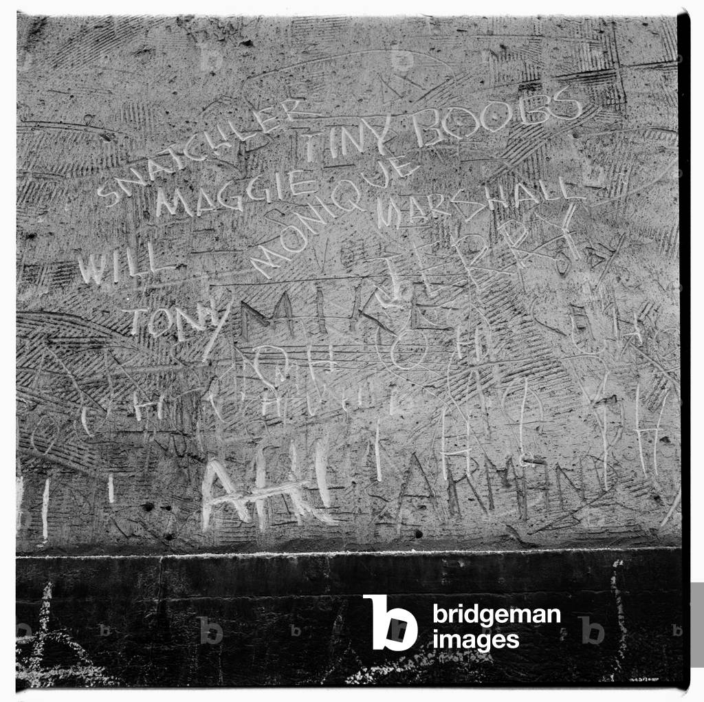 Image of graffiti in wet cement including English "tiny boobs", Paris early early 1950's