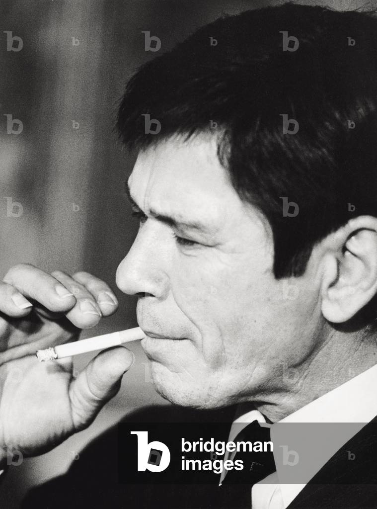 Image of Charles Bronson smoking a cigarette on the set