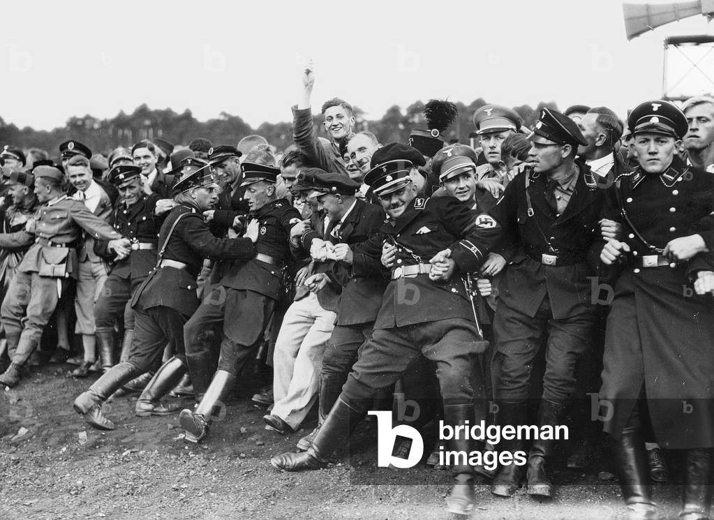 Image of Photography depicting Shut-off teams hold back the crowd on the Nuremberg Rally 1935, b/w