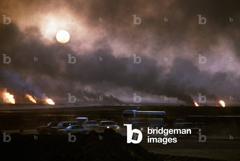 Image of The smoke from oil well fires forces Kuwait drivers to