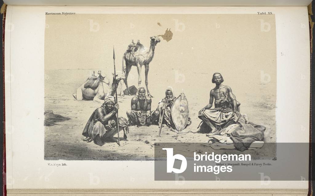 Un gruppo di nomadi, con due cammelli sullo sfondo