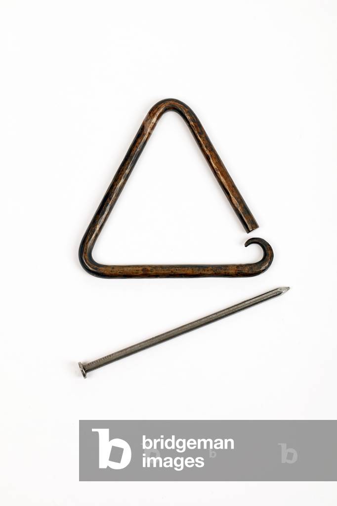 Image of Photography depicting Ornate hand-beaten bronze Triangle with decorative curled or curved lower point