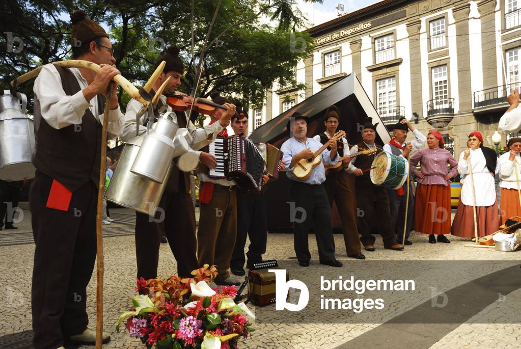 Festive folk dancers with folk music group