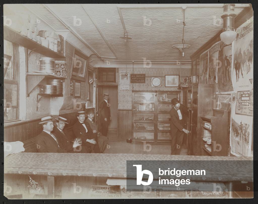 Image of Photography depicting Empire Film Co (possibly at Broadway and 55th Street) with movie posters on wal