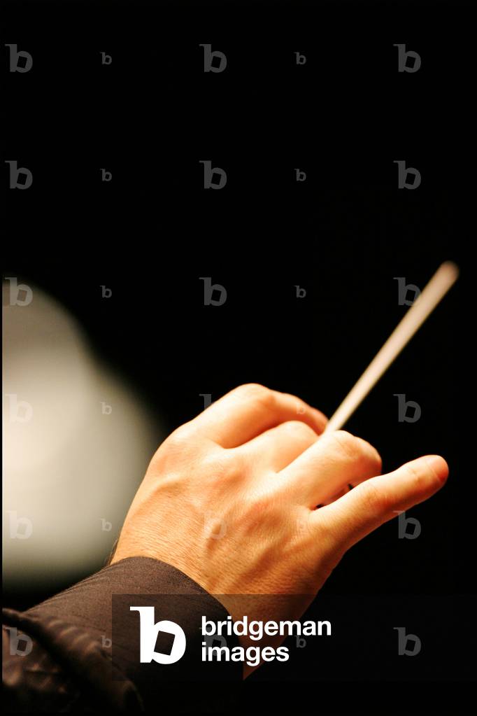 Image of Conductor's hand holding baton