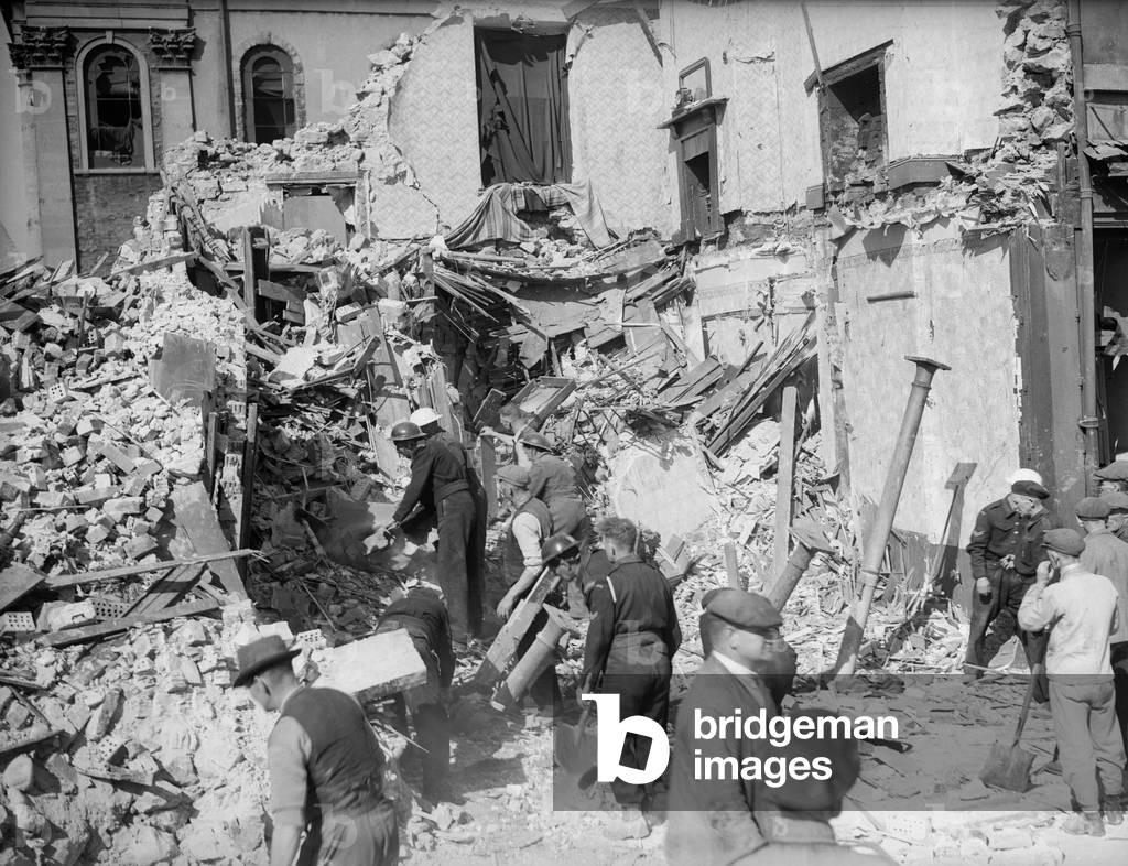 WW2 Air Raid Damage Bomb damage in Cardiff people survey the wreckage and rubble caused by the