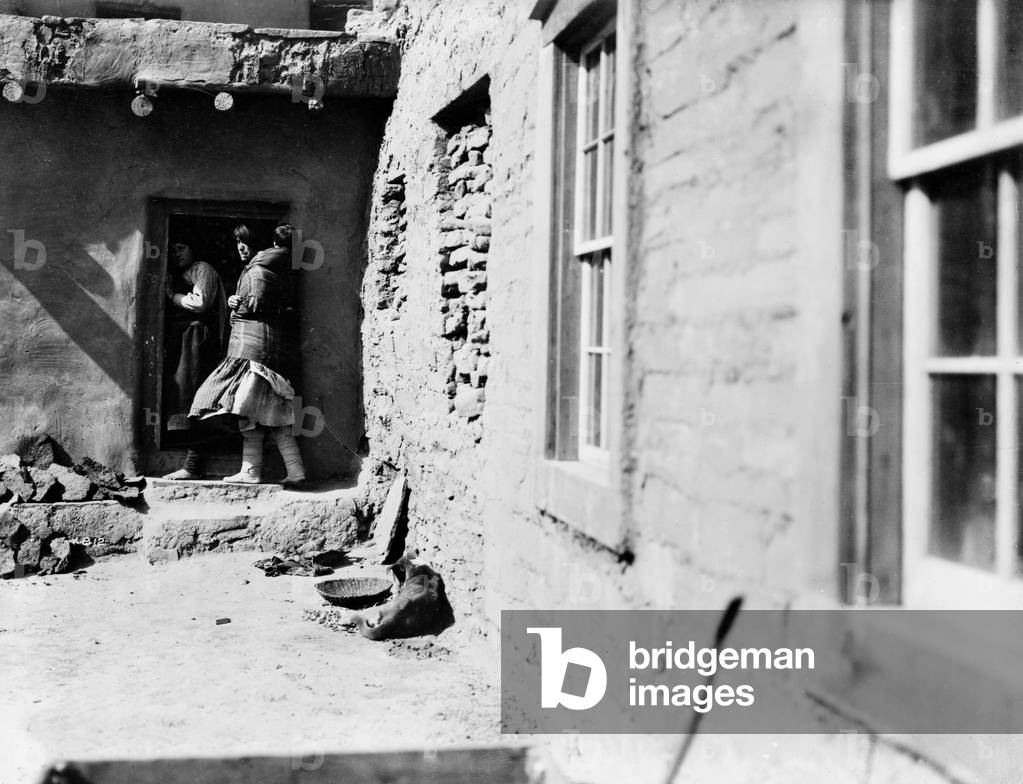 Image of ZUNI PUEBLO, c.1903 Zuni Native Americans in a doorway in