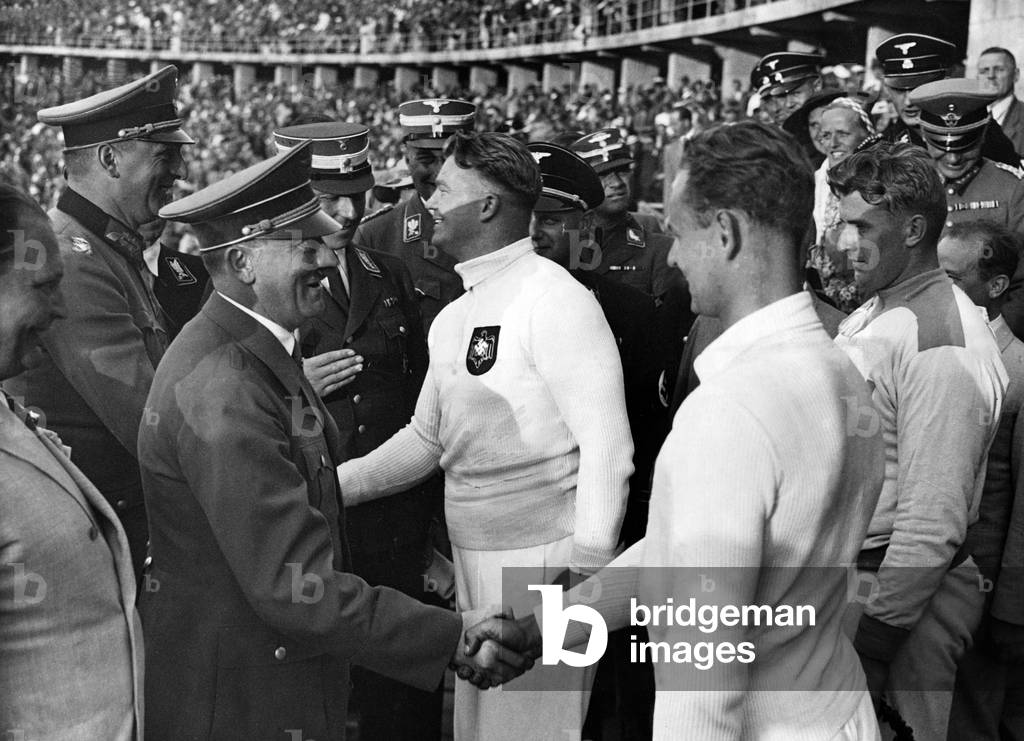Image of Adolf Hitler congratulates the shot put winners, 1936 (b/w photo)