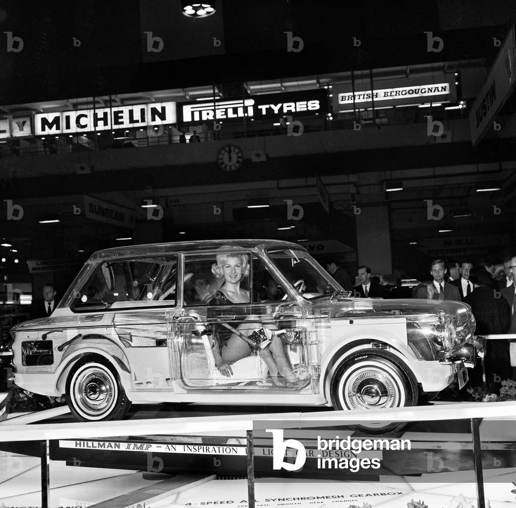 Model Caron gardner sits inside a Hillman Imp built of perspex to show