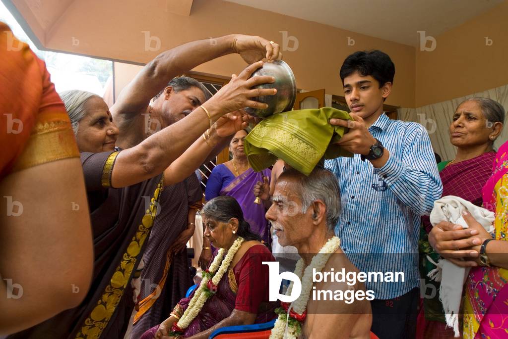 Image of Hinduism Family members performing special Vedic fire