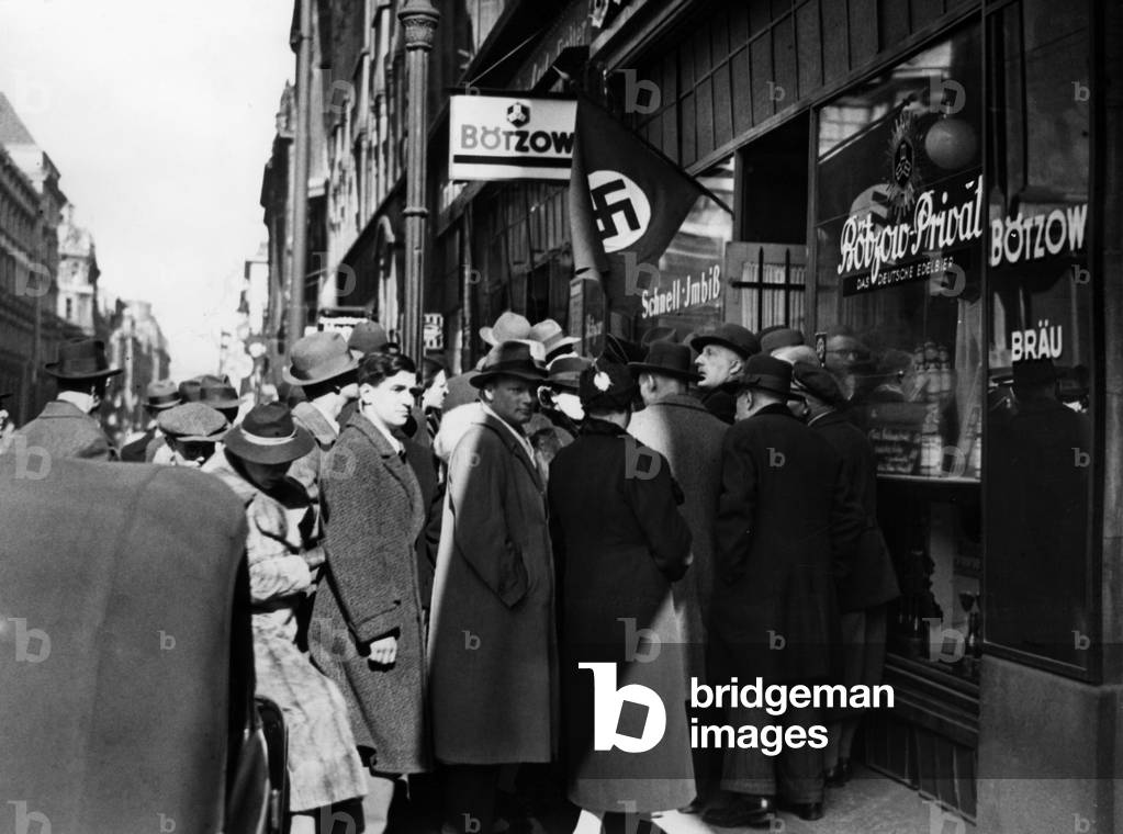 People of Berlin listen to the proclamation of the so-called "Anschluss", b/w