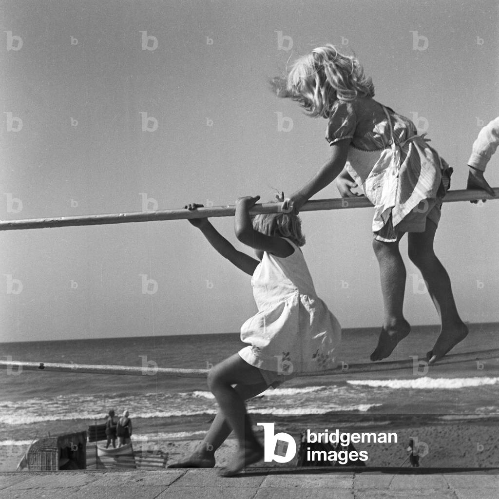 Image of Photography depicting Two little girls playing at a railing at the shore of the Baltic Sea in East Pr