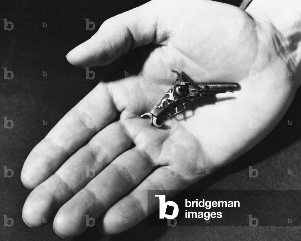 Closeup of a 16th Century German Wheelock Pistol on a man's palm by