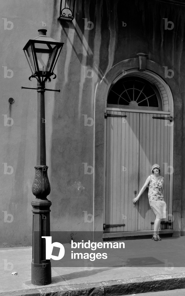 Woman in flapper style clothing stands on street in Old French Quarter of New Orlea..., 1929 (photo)