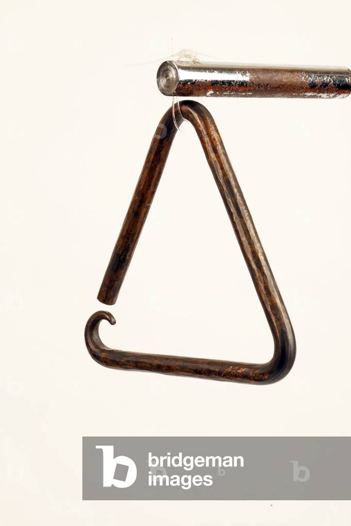 Image of Photography depicting Ornate hand-beaten bronze Triangle with decorative curled or curved lower point