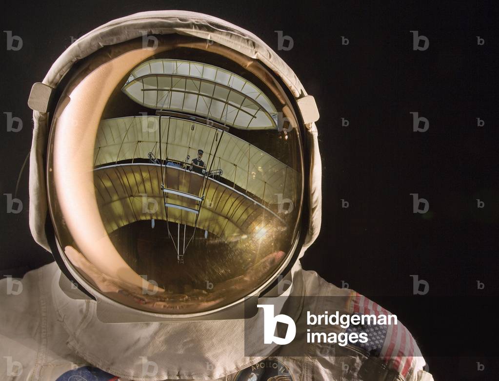 Image of Apollo helmet visor reflecting the 1903 Wright Flyer (photo)