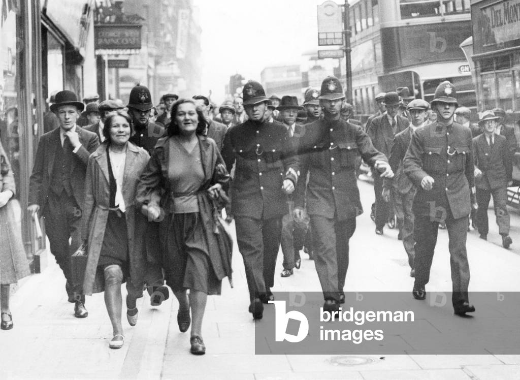 Police escort demonstrators in London, 1931 (b/w photo) by