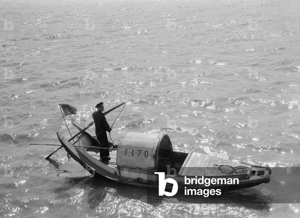A starboard broadside view of the sampan numbered 1170 being sculled at ...