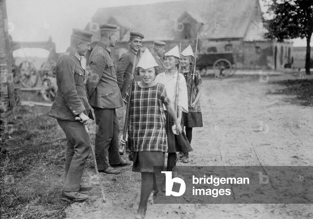 Girls parade with paper helmets, 1925 (b/w photo)