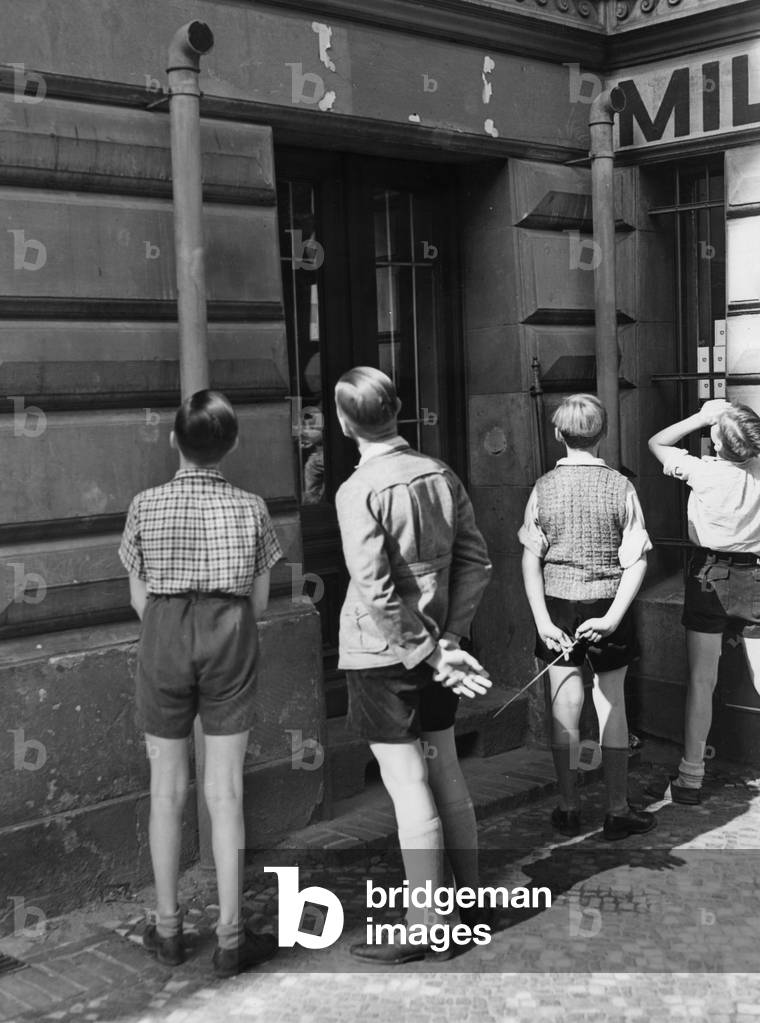 Children look at the ventilation pipes at an air raid shelter in Berlin